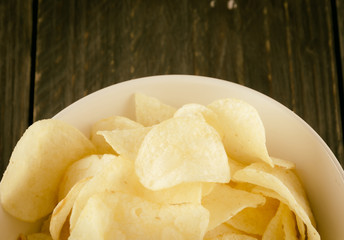 potato chips on wood - soft focus with vintage film filter