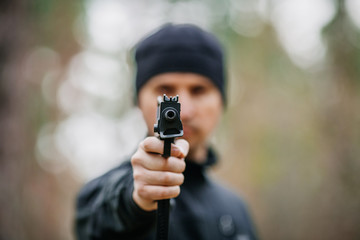 man with gun on a outdoor background
