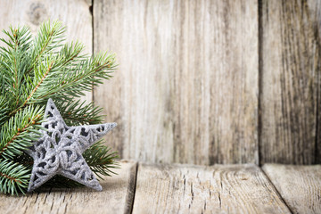 Christmas decoration with fir branches on the wood background.