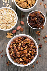 Granola and ingredients on wooden table