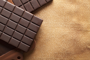 Dark chocolate on old paper background