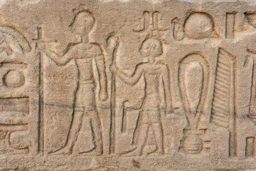 old egypt hieroglyphs carved on the stone. Detail from temple wa