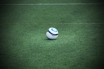 Soccer ball on green field