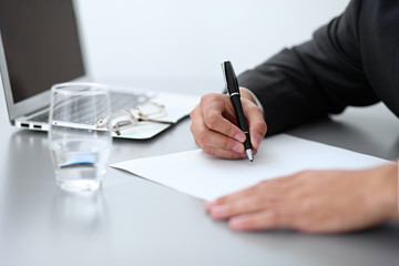 Close-up of male hands with pen over document,  business concept