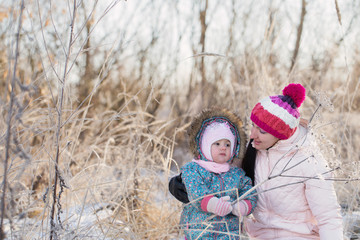 Happy family playing in winter outdoors