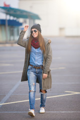 young woman in urban wear style with different emotions on parki