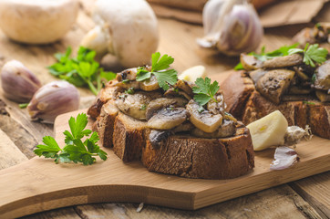Mushroom mixture on rustic toast with garlic
