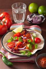 vegan taco with avocado tomato kidney beans and salsa