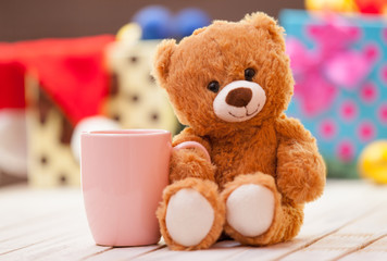 Teddy bear with cup of coffee or tea