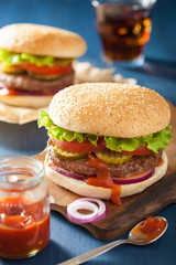 burger with beef patty lettuce onion tomato ketchup