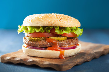 burger with beef patty lettuce onion tomato ketchup