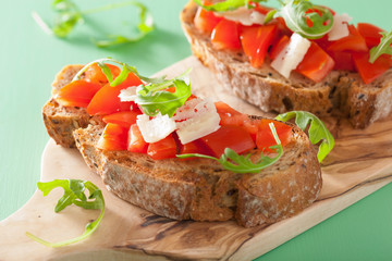 italian bruschetta with tomatoes parmesan arugula