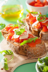 italian bruschetta with tomatoes parmesan arugula
