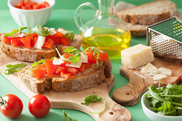 italian bruschetta with tomatoes parmesan arugula