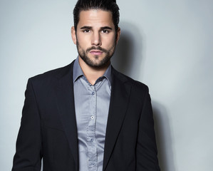 handsome young man in suit on grey background. Business man