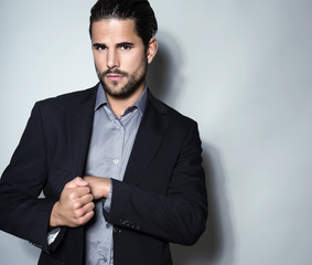handsome young man in suit on grey background. Business man