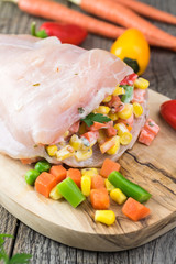 Uncooked stuffed chicken breast.