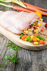 Uncooked stuffed chicken breast.