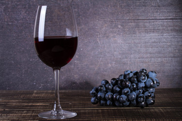 Glass and grape on wooden background. Still life