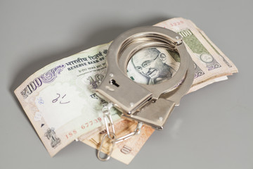 Indian Currency Rupee Notes and Handcuffs