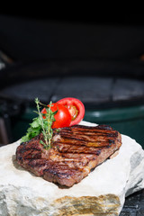 stages of cooking steak on the grill - ready piece of grilled steak with a grill in the background focus on different parts of the meat
