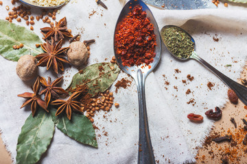 mix of different spices and herbs, cook and cuisine ingredients on the table with the decor of bay leaf and fruit