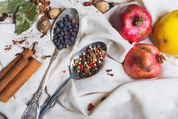 mix of different spices and herbs, cook and cuisine ingredients on the table with the decor of bay leaf and fruit