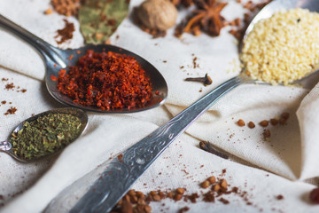 mix of different spices and herbs, cook and cuisine ingredients on the table with the decor of bay leaf and fruit