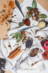 Top view mix of different spices and herbs, cook and cuisine ingredients on the table with the decor of bay leaf and fruit