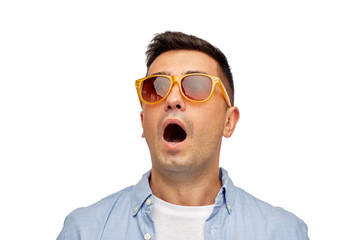 face of scared man in shirt and sunglasses