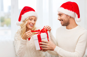 happy couple at home with christmas gift box
