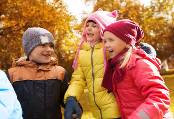 group of happy children in autumn park