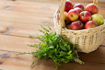 close up of melissa and basket with apples