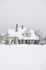 a private house and its garden under snow in winter