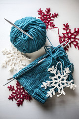 unfinished knitted hat with crocheted snowflakes in contrast