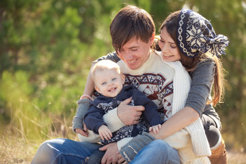 Family resting in autumn forest