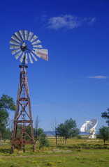 Radio telescope and old windmill at the National Radio Astronomy Observatory in Socorro, NM