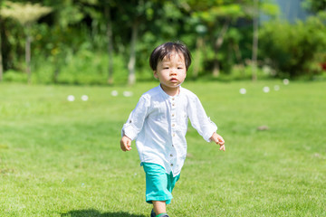 Little boy walking though at park