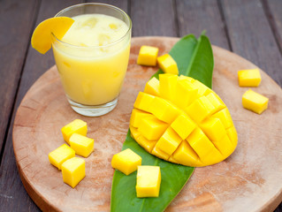 Mango juice, smoothie ,mango fruit on a wooden background