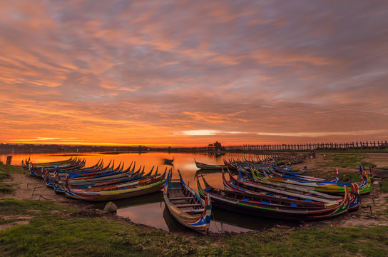 Wooden boat in Ubein Bridge at sunrise, Mandalay, Myanmar (World longest wooden bridge)