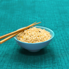 Bowl of freshly made egg fried rice, with chop sticks.