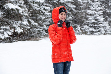 Pretty young woman playing snowballs