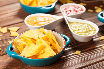Plate of nachos with different dips
