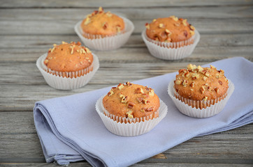 Homemade banana muffins with pecans on the wooden table