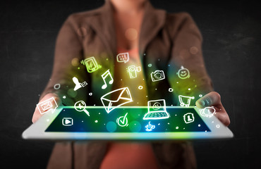 Person holding a tablet with media icons and symbols