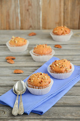 Homemade banana muffins with pecans on the wooden table