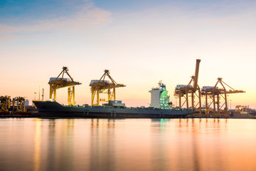 Fototapeta na wymiar Container Cargo freight ship with working crane bridge in shipya