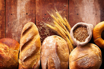 Baked bread on wooden table background