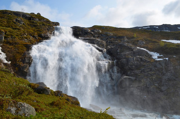Fototapeta na wymiar Large waterfall on mountain slope, Swedish subarctic Lapland