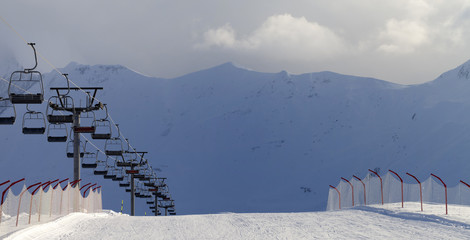 Panoramic view on snow skiing piste and ropeway